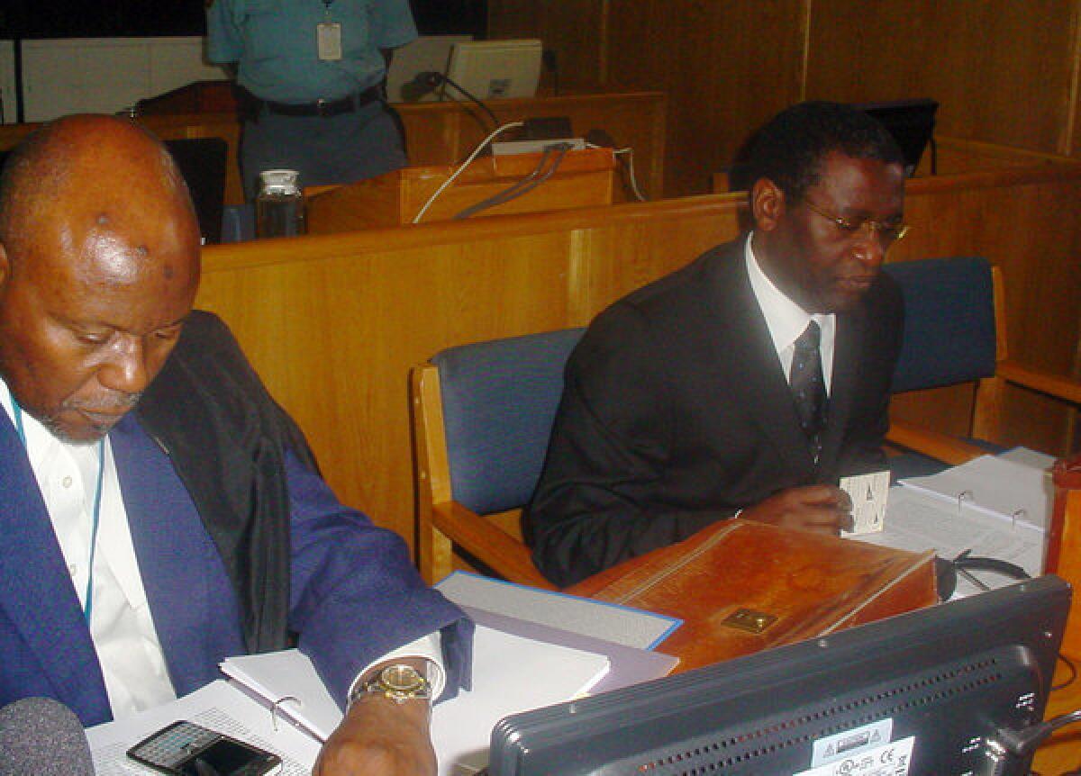 Former Rwandan Planning Minister Augustin Ngirabatware, right, sits next to his lawyer Cecil John Maruma during his first appearance before the International Criminal Tribunal for Rwanda in Arusha, Tanzania.