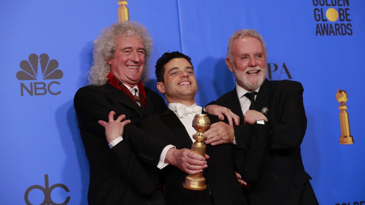 Queen members Brian May, left, and Roger Taylor, right, pictured with Rami Malek after his Golden Globe win for lead actor in a drama for "Bohemian Rhapsody."