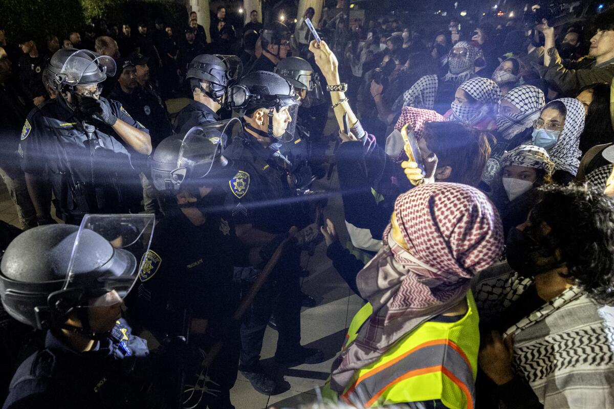 University of California Police officers face pro-Palestinian protesters outside Dodd Hall at UCLA