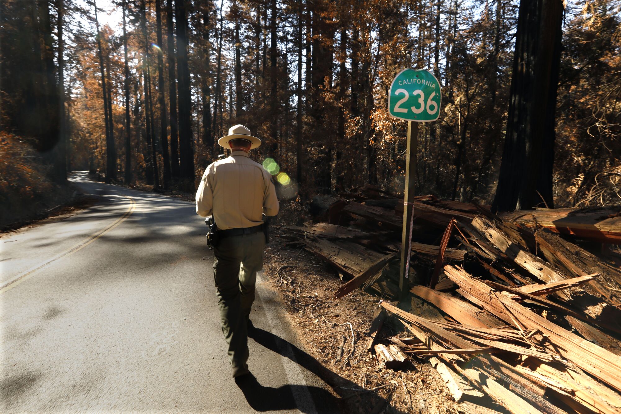 Gabe McKenna, a State Parks' safety officer and ranger, walks along Highway 236