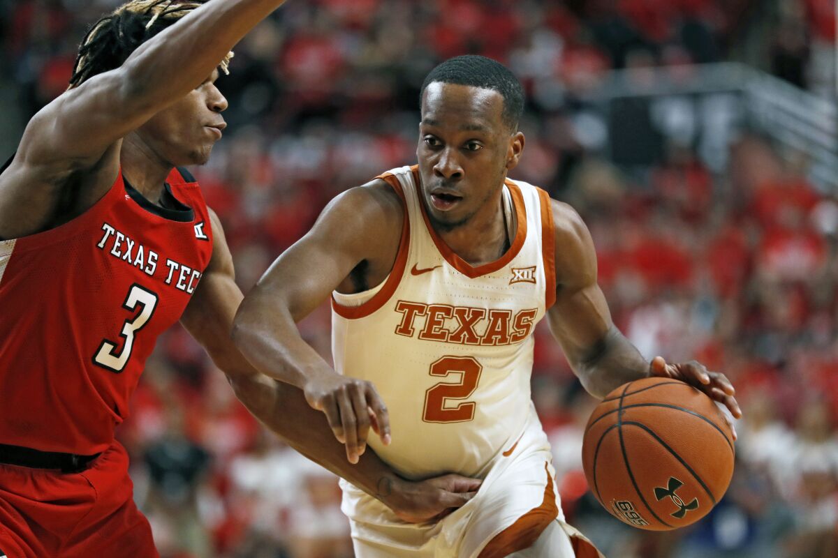 FILE - In this Feb. 29, 2020, file photo, Texas' Matt Coleman III (2) drives the ball around Texas Tech's Jahmi'us Ramsey (3) during the first half of an NCAA college basketball game in Lubbock, Texas. Coleman is the floor leader who has seen everything. Andrew Jones and Courtney Ramey bring playmaking and defense. Those three found a rhythm that propelled a five-game win streak late last season. (AP Photo/Brad Tollefson, File)
