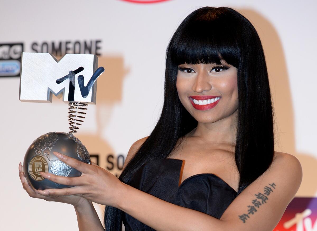 Nicki Minaj poses for pictures after being awarded the title 'Best Hip Hop' during the 2014 MTV Europe Music Awards.