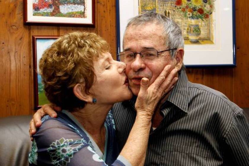 USC chemistry professor Arieh Warshel gets a congratulatory kiss from his wife, Tami, at their Los Angeles home after he learned he and two colleagues had been awarded the Nobel Prize in chemistry.