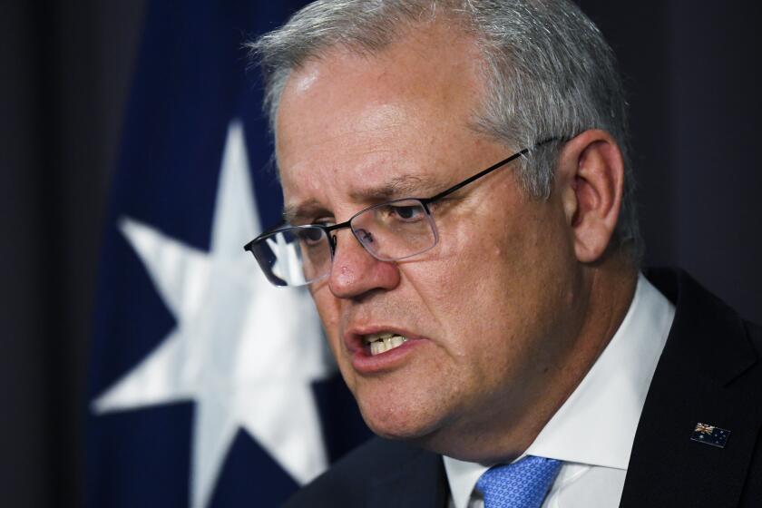 Australian Prime Minister Scott Morrison speaks to the media during a press conference at Parliament House in Canberra, Thursday, Nov. 12, 2020. Morrison announced a new investigative agency to build criminal cases against Australian special forces suspected of committing war crimes in Afghanistan. (Lukas Coch/AAP Image via AP)