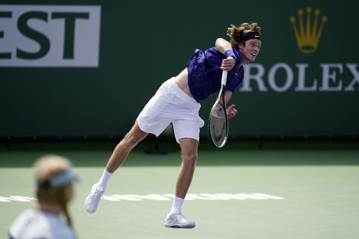 Andrey Rublev, of Russia, serves to Dominik Koepfer, of Germany, at the BNP Paribas Open tennis tournament Sunday, March 13, 2022, in Indian Wells, Calif. (AP Photo/Marcio Jose Sanchez)