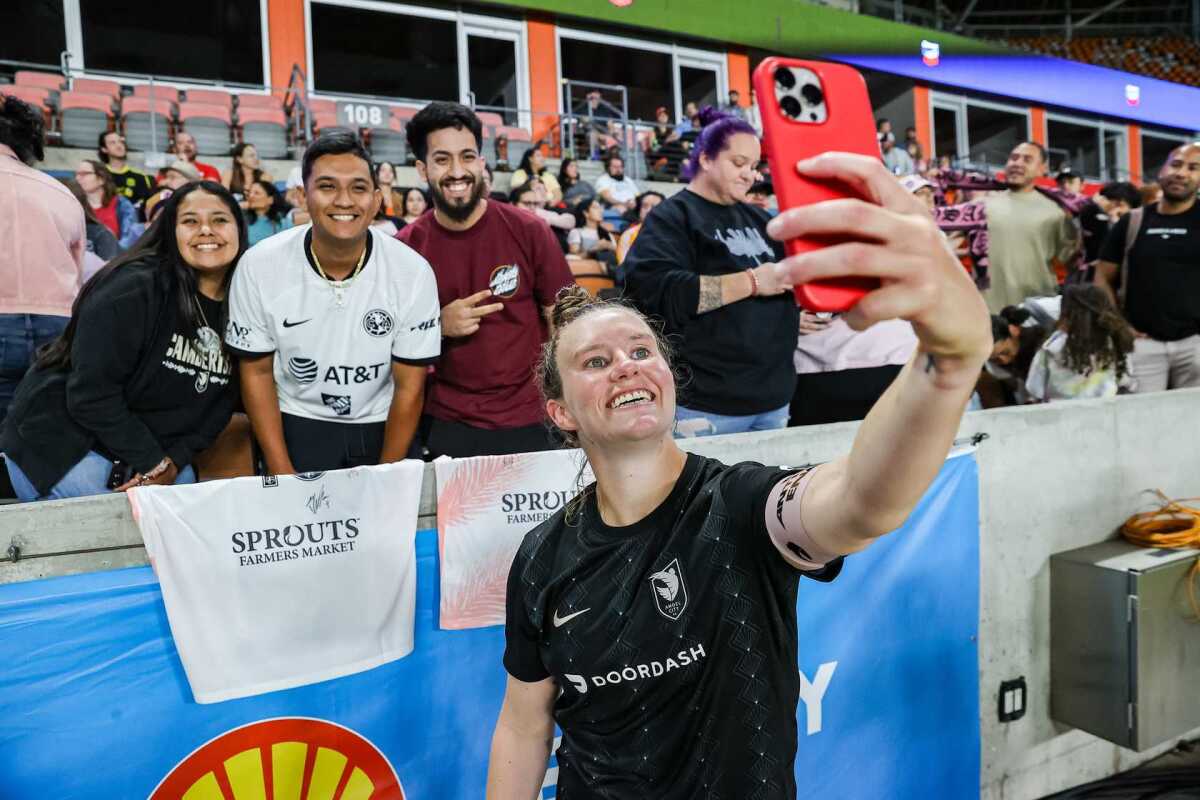 Angel City's Savannah McCaskill takes a selfie with fans after a game during the 2023 season.