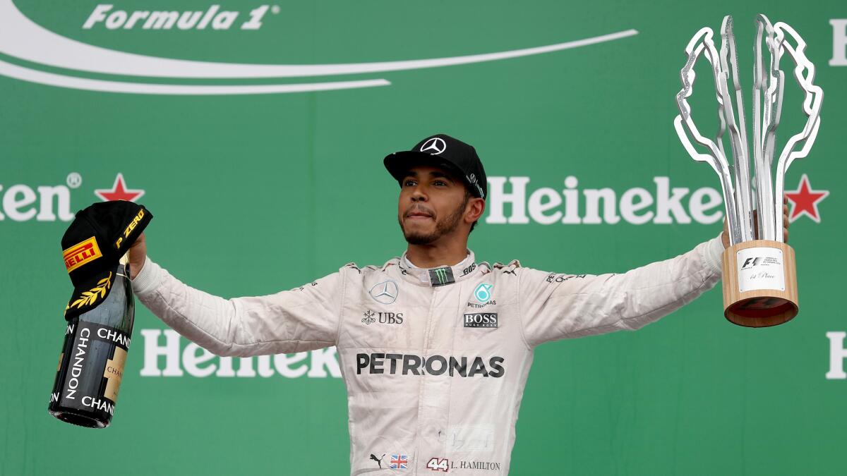 Formula One driver Lewis Hamilton celebrates on the podium after winning the Canadian Grand Prix on Sunday in Montreal.