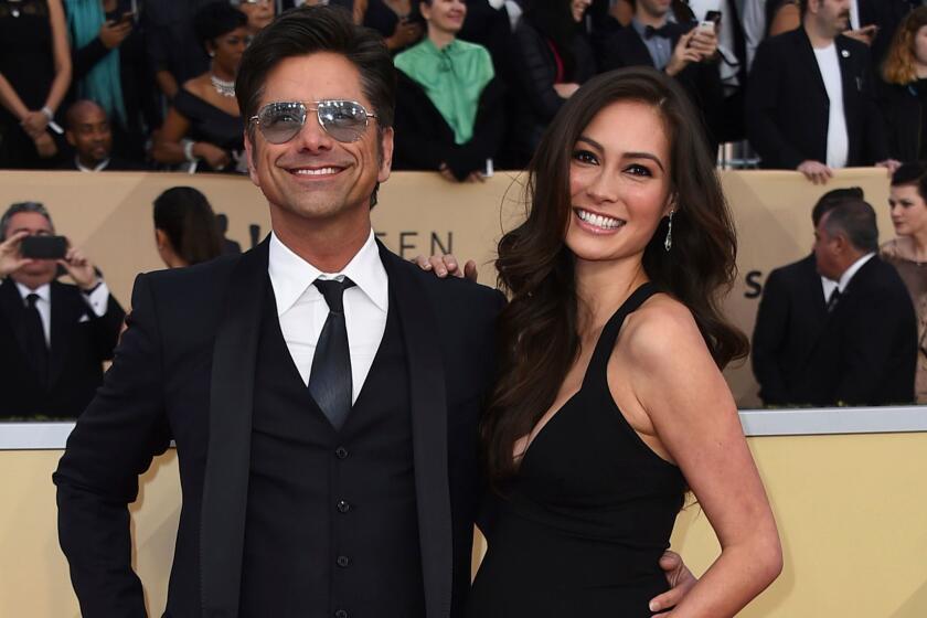 FILE - In this Jan. 21, 2018 file photo, John Stamos, left, and Caitlin McHugh arrive at the 24th annual Screen Actors Guild Awards at the Shrine Auditorium & Expo Hall in Los Angeles. Police say burglars stole $165,000 in jewelry from a room at the Beverly Hills Hotel that was occupied by McHugh. A police statement says Caitlin McHugh was away from her room Friday, Feb. 2, when a crook or crooks got in and took several items of jewelry. Itâs unclear how the burglars got inside. Thereâs no indication of forced entry.(Photo by Jordan Strauss/Invision/AP, File)