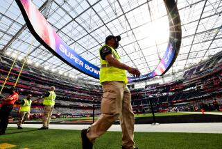 Inglewood, CA - February 13: Security walks the field before the start ofSuper Bowl LVI at SoFi Stadium on Sunday, Feb. 13, 2022 in Inglewood, CA.(Robert Gauthier / Los Angeles Times)