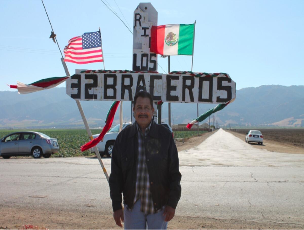 Salvador Flores Barragan stands in front of a memorial cross