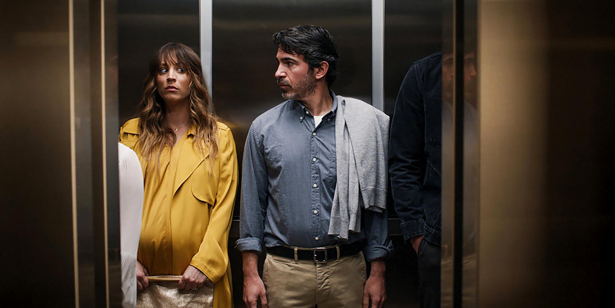 A pregnant woman and a man stand in an elevator looking startled in "Based on a True Story."