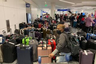 Baggage waits to be claimed after canceled flights at the Southwest Airlines terminal at Los Angeles International Airport on Monday, Dec. 26, 2022, in Los Angeles. (AP Photo/Eugene Garcia)