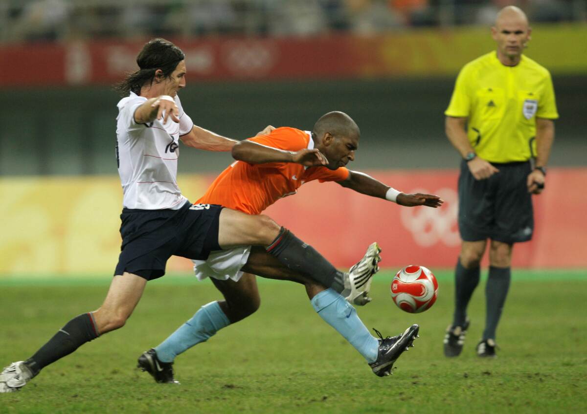U.S. midfielder Sacha Kljestan, left, battles Ryan Babel of the Netherlands for the ball.