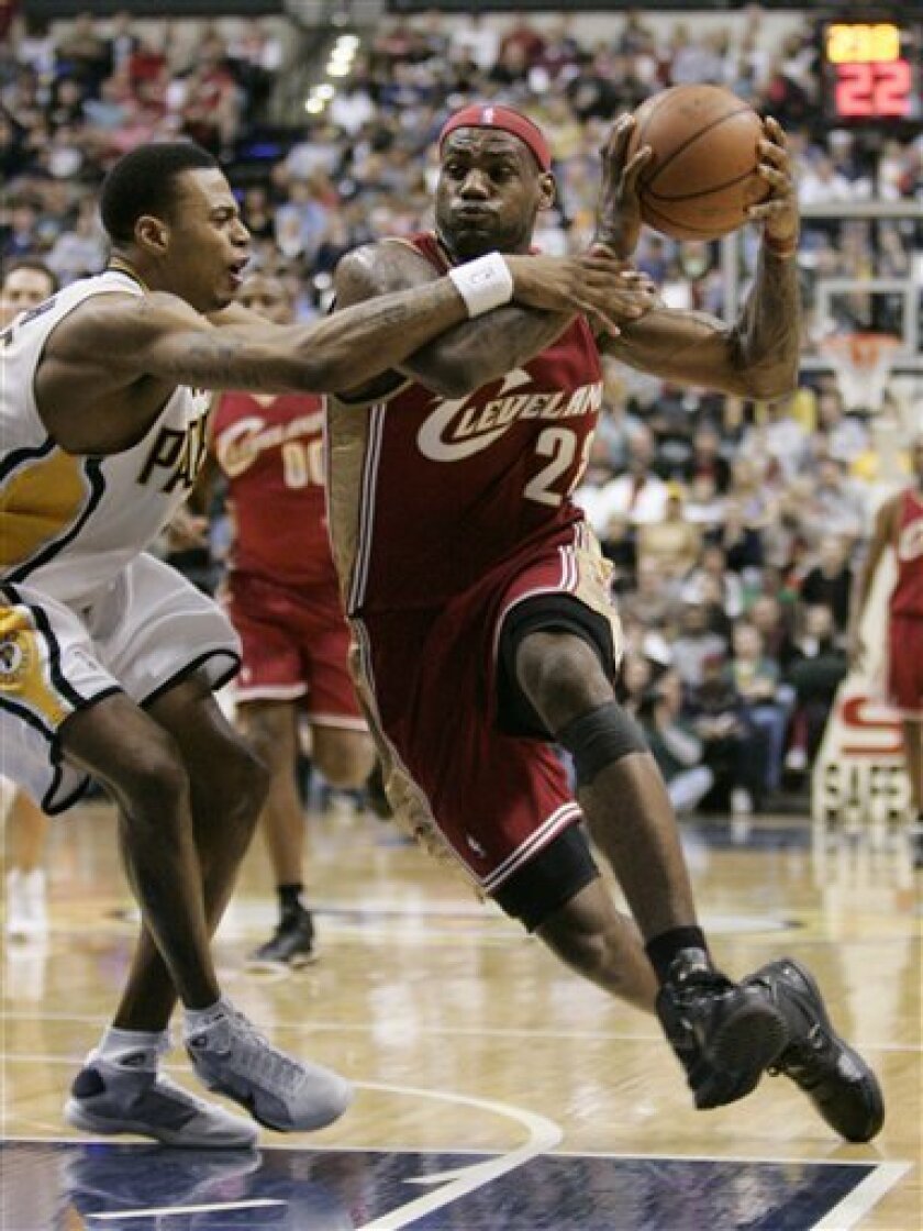 Cleveland Cavaliers' LeBron James, right, is fouled by Indiana Pacers' Brandon Rush in the first half of an NBA basketball game in Indianapolis, Monday, April 13, 2009. (AP Photo/Michael Conroy)