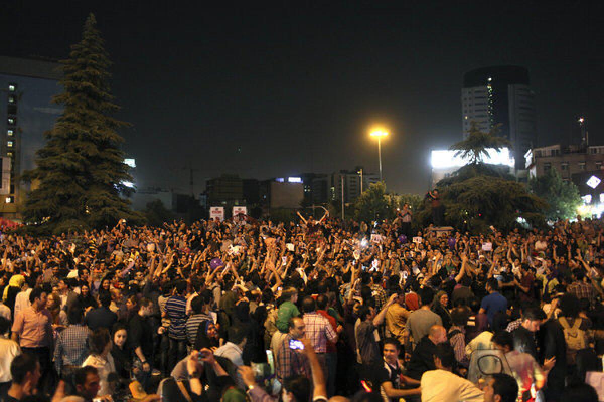 Supporters of Iranian presidential candidate Hassan Rowhani attend a Tehran celebration gathering following his victory June 15, 2013.