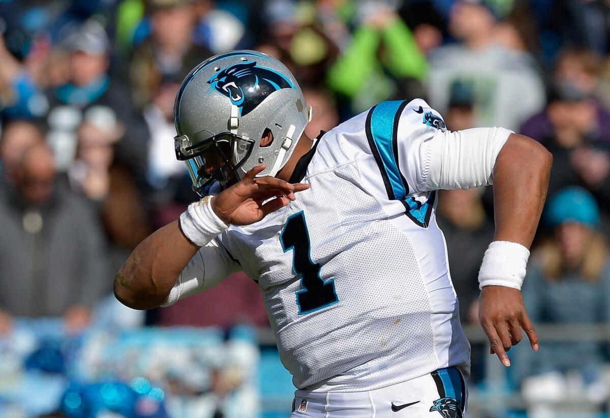 Cam Newton dabs during a game in Seattle on Jan. 17.