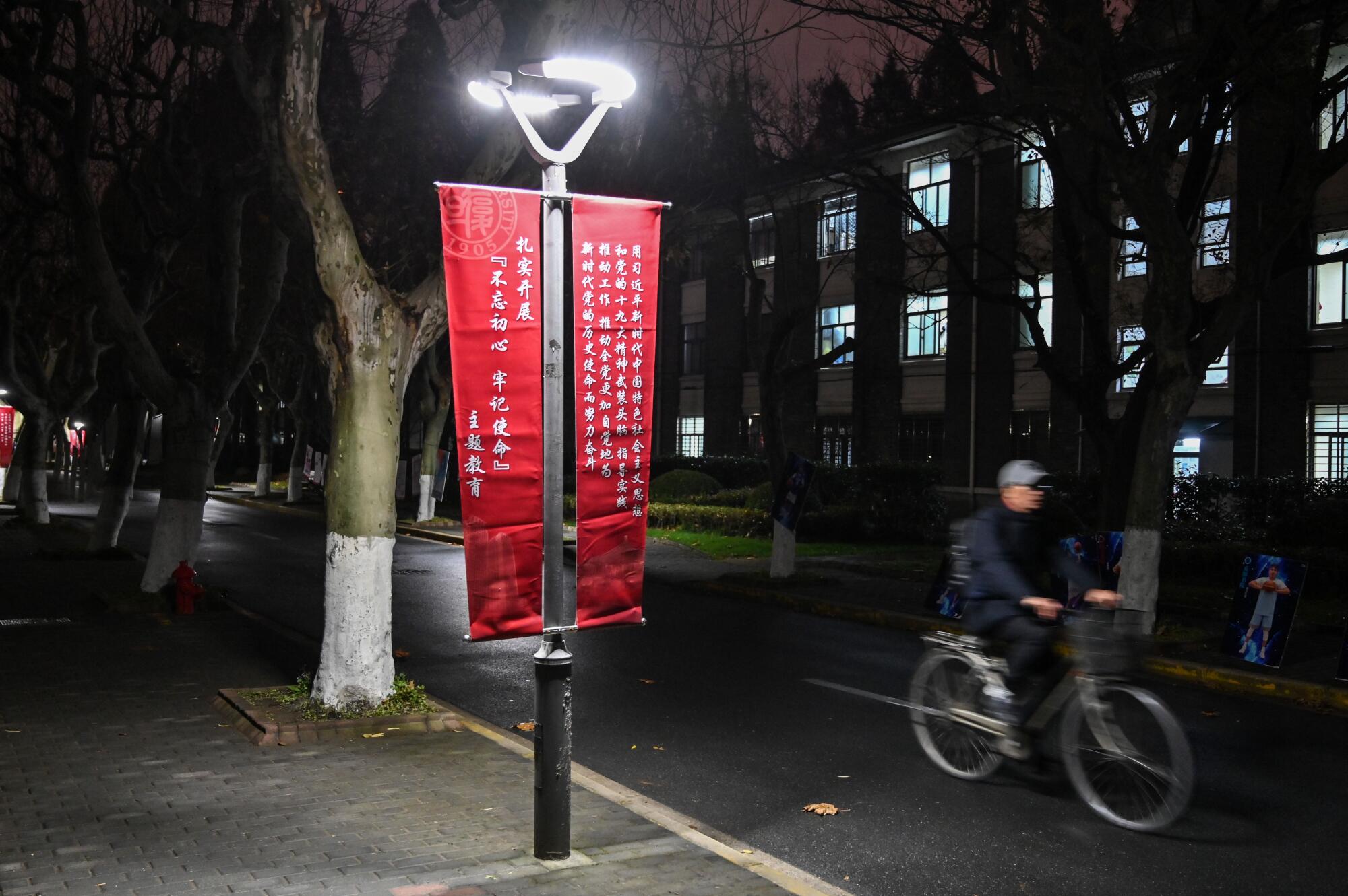 A banner at Fudan University in Shanghai calls for institutions to adhere to the philosophy of Chinese President Xi Jinping.