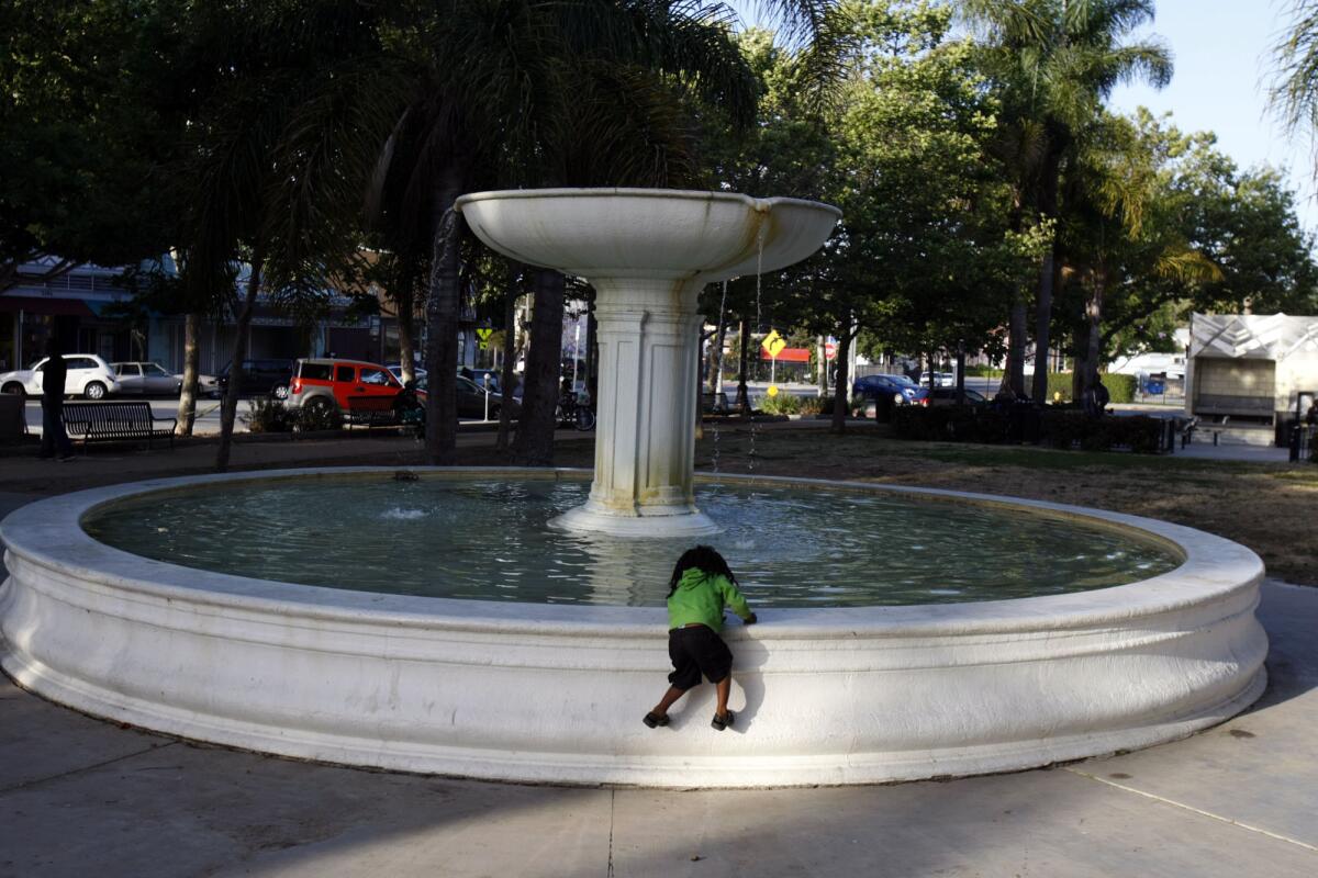 A young girl plays at the fountain at Leimert Park, not far from a future MTA station.