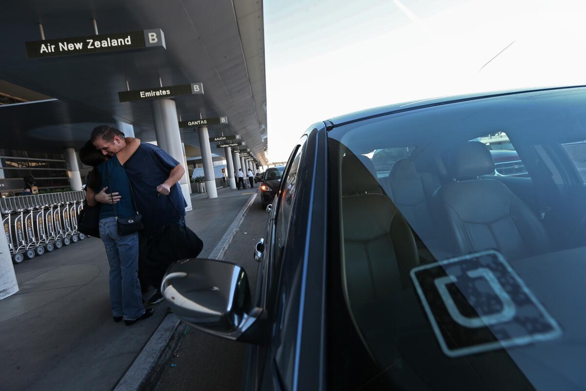 An Uber driver drops off a passenger at Los Angeles International Airport. A new law ensures that state workers are reimbursed for using Uber and other sharing-economy businesses for business travel.