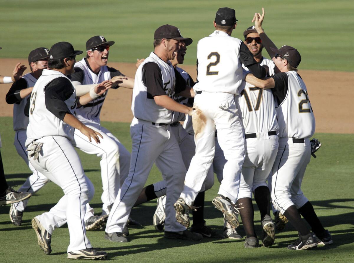 Members of the Foothill baseball team swarm pitcher Sebastian Lopez (17) after defeating JSerra during the Southern Section Division 1 semifinal on June 3, 2014.