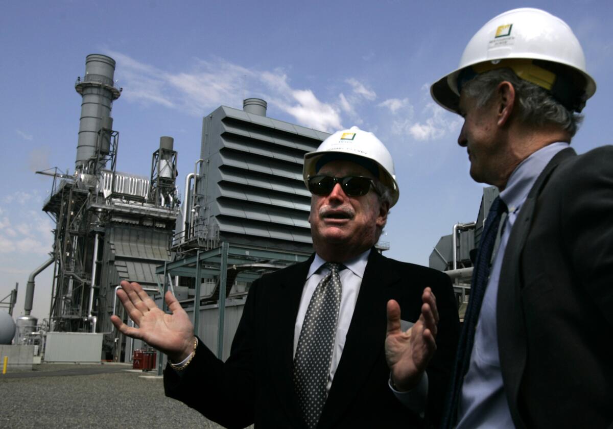 California Public Utilities Commission President Michael Peevey, left, chats with then-Edison International Chairman John Bryson after the company dedicated the Mountainview generating facility in Redlands.