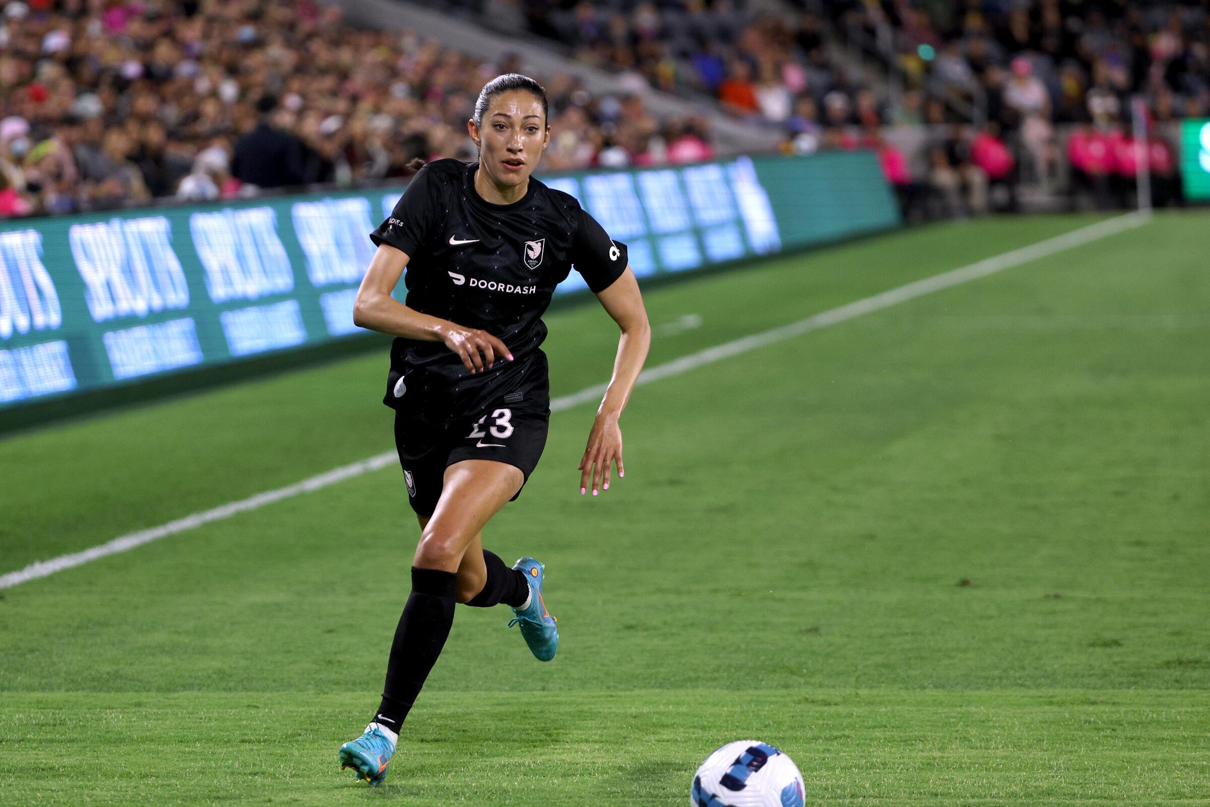 Angel City's Christen Press controls the ball during a match at BMO Stadium in 2022.
