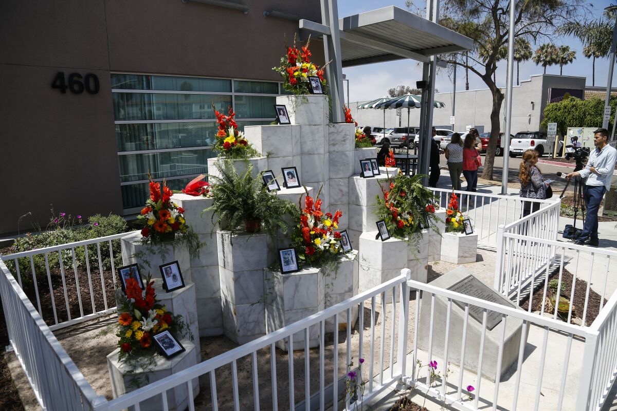 Flowers and photos of victims of a 1984 mass shooting are shown at a memorial.