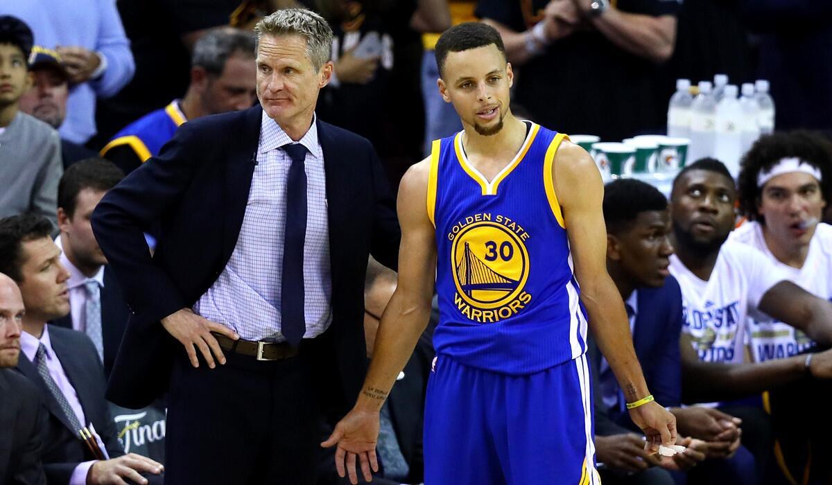 Golden State Warriors Coach Steve Kerr, left, and guard Stephen Curry react in the second half against the Cleveland Cavaliers in Game 6 of the NBA Finals on Thursday.