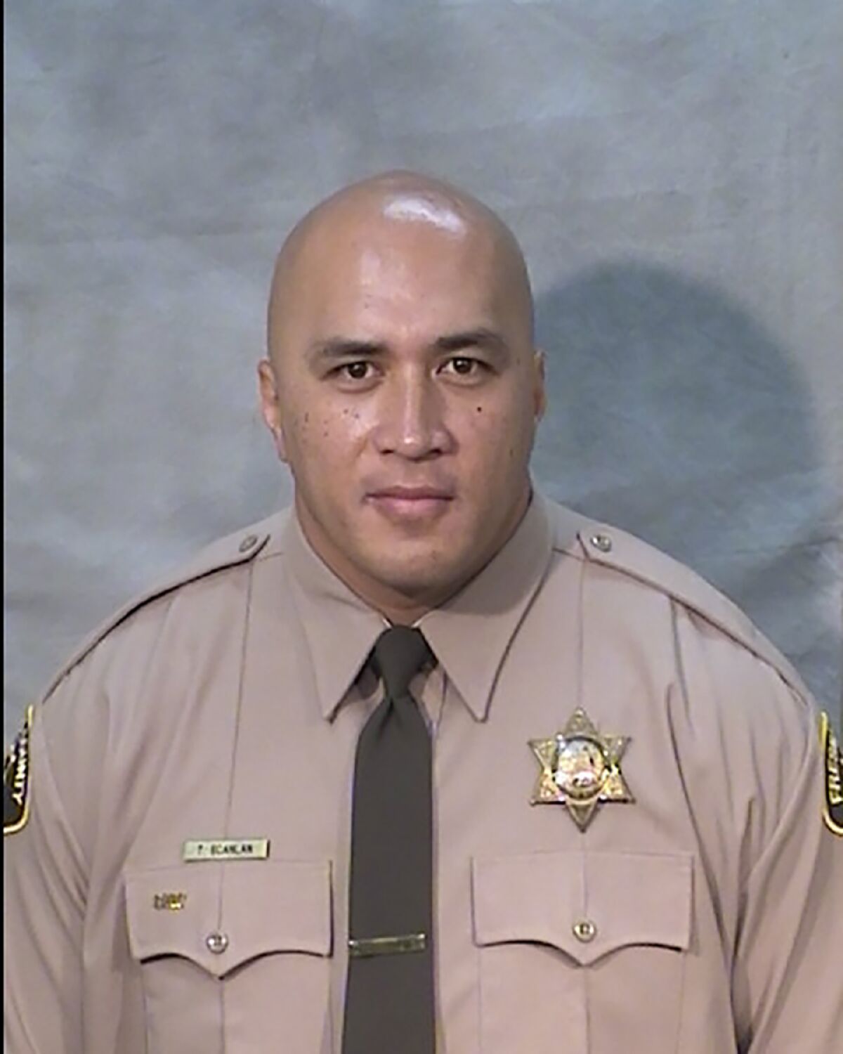 FILE - This undated handout photo provided by the Fresno County Sheriff's Department shows Fresno Deputy Sheriff Toamalama Scanlan. Scanlan succumbed to injuries, sustained in a 2016 jail lobby shooting and died Tuesday, Oct. 12, 2021. Scanlan has been hospitalized since Sept. 3, 2016, when he came to the aid of a fellow officer in the lobby of the main jail. Scanlan, 46, is survived by his wife and six children. (Fresno County Sheriffs Office Photo via AP, File)