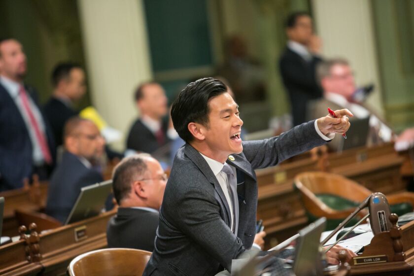 Assemblyman Evan Low (D-Campbell) jeers fellow lawmakers as they race to vote on bills on the last day of the legislative year in Sacramento.