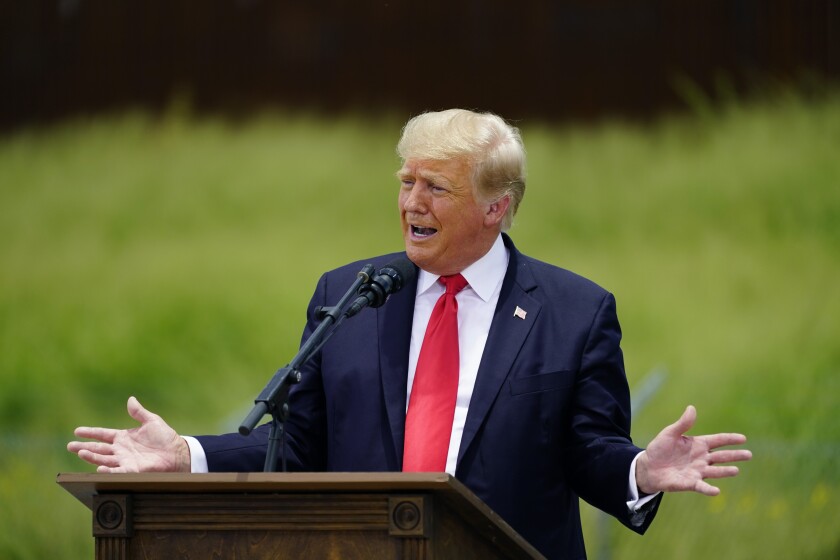 Former President Trump speaks at a lectern.