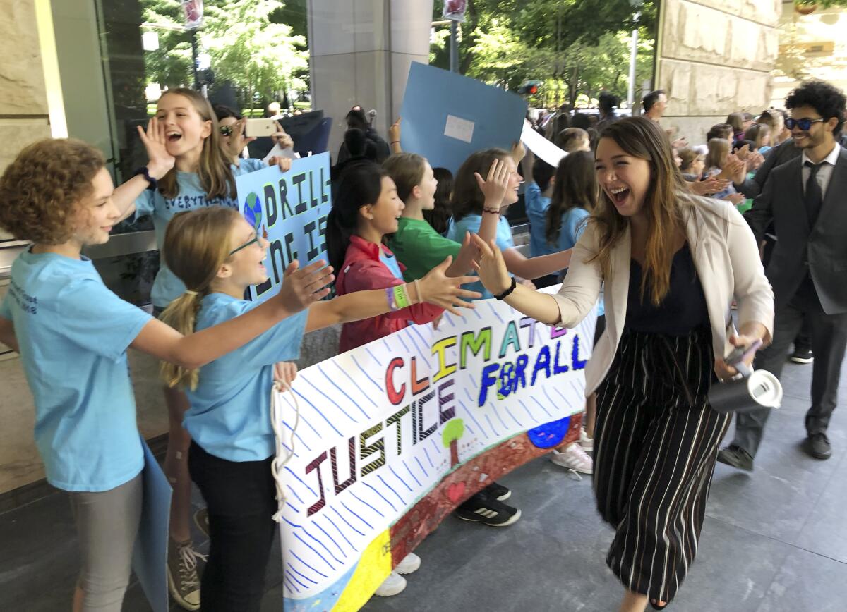 Kelsey Juliana, of Eugene, Ore., greets supporters outside a federal courthouse in Portland on June 4, 2019. Juliana was a lead plaintiff in a climate change lawsuit that was dismissed on Friday.