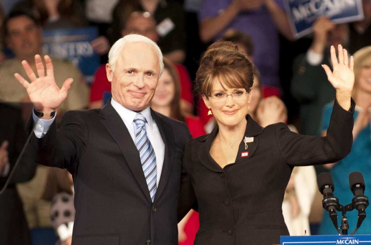 Ed Harris as 2008 presidential hopeful John McCain and Julianne Moore as Sarah Palin wave to supporters in "Game Change."