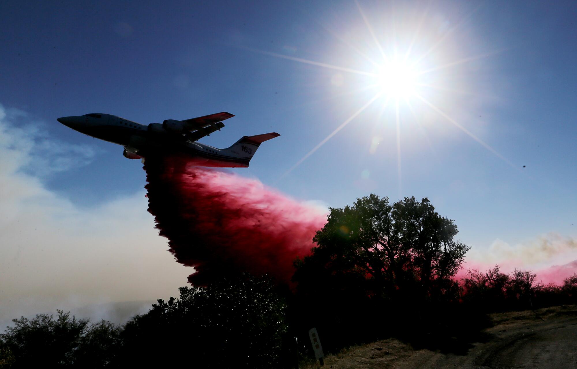 A firefighting airplane drops fire retardant ahead of the Alisal fire near Goleta on Wednesday.