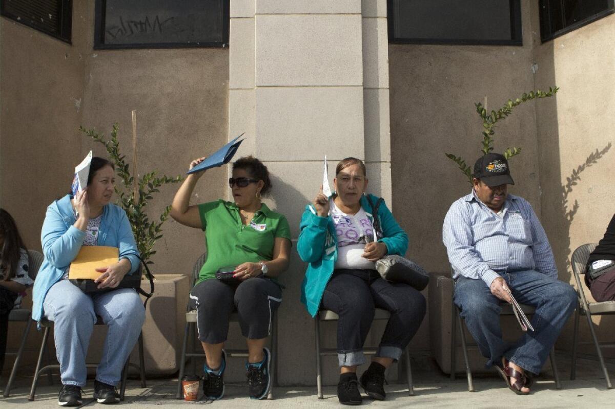 People wait to sign up for health insurance Nov. 15 in Los Angeles when the open enrollment period began under the federal Affordable Care Act.