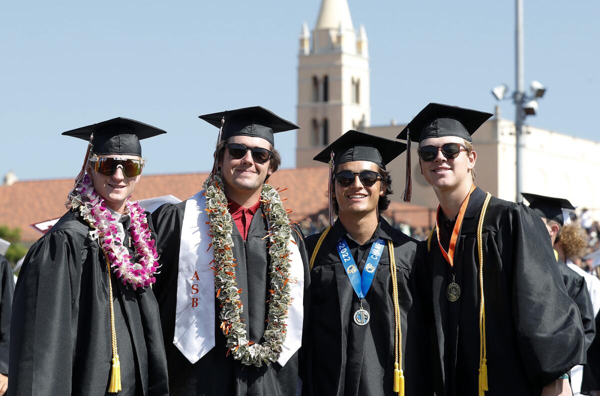 Athlete graduates Shane Featherston, Tyler Moses, Cade Hart and Ben Jacobs, from left, gather for a moment Tuesday.