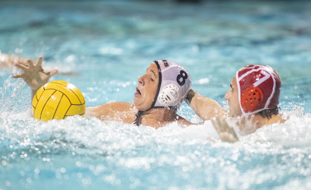 Huntington Beach's James Rozolis-Hill battles for the ball with Orange Lutheran's Seth Kacura in the first round of the CIF Southern Section Division 1 playoffs at Santiago Canyon College in Orange on Thursday.