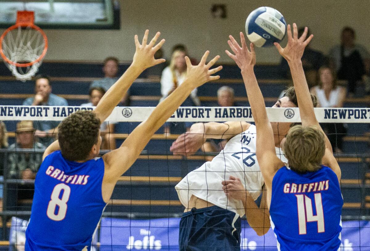 Newport Harbor's James Eadie hits against Los Alamitos' Beck Weber, left, and Nate Baddeley on Tuesday.