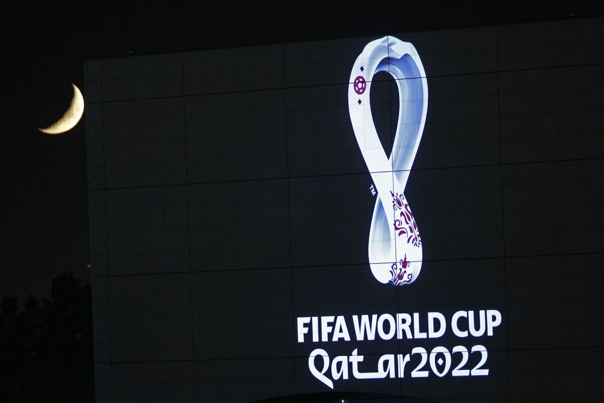 FILE - The 2022 Qatar World Cup logo is projected on the opera house of Algiers, Tuesday Sept. 3, 2019. 