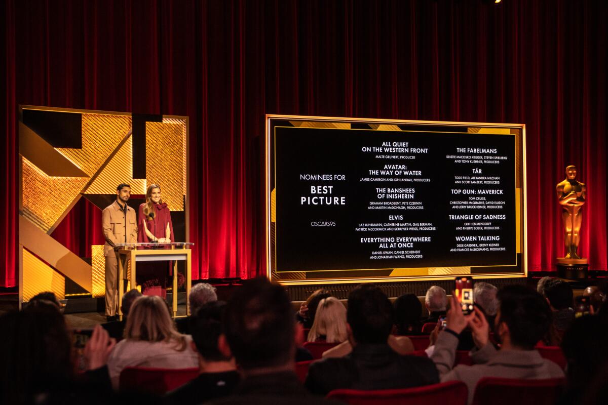 Riz Ahmed and Allison Williams announce the Oscar nominations on stage.