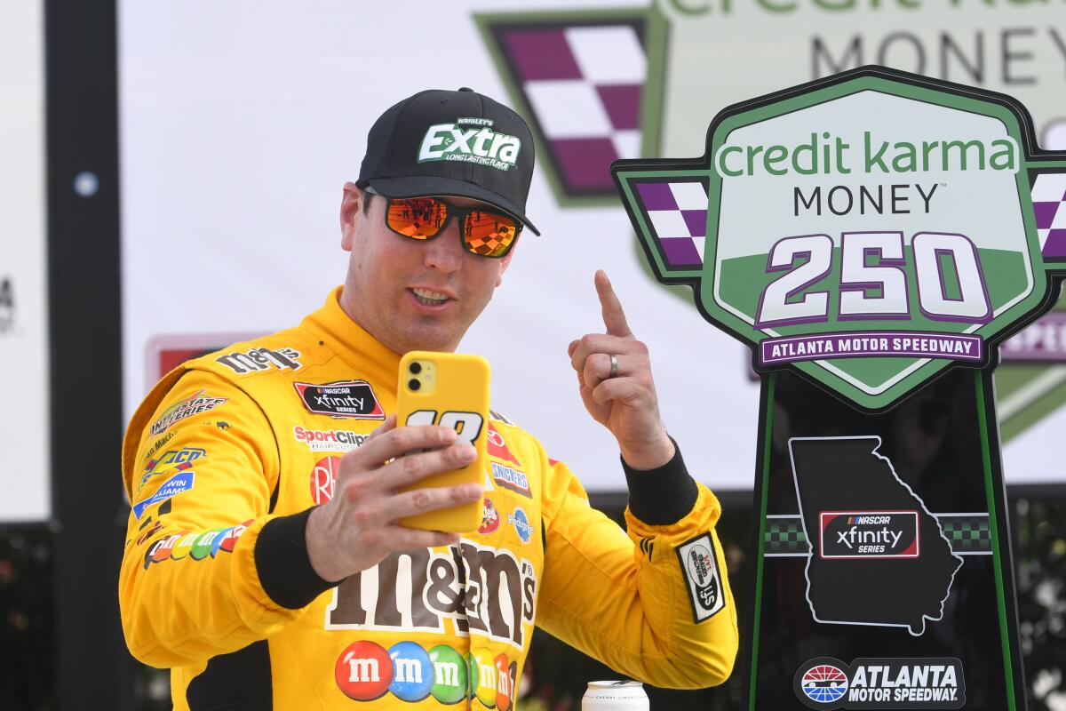 Kyle Busch celebrates after winning a NASCAR Xfinity Series race Saturday in Hampton, Ga.