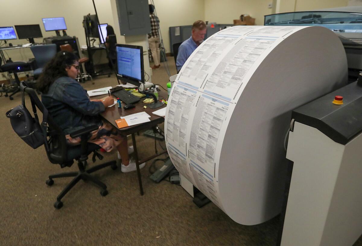 A wheel of printed ballot material is set to be cut and processed at the Orange County Registrar of Voters Santa Ana office.