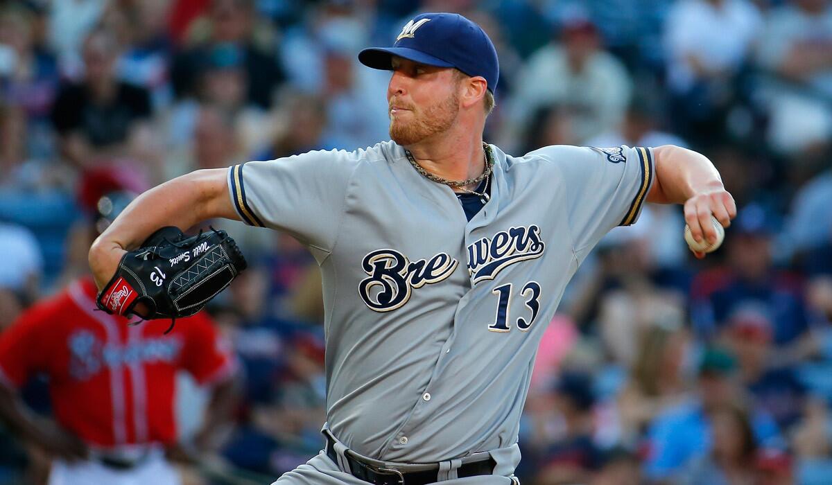 Milwaukee Brewers pitcher Will Smith pitches in the eighth inning against the Atlanta Braves on May 23. Smith's eight-game suspension for having a foreign substance on his arm during a game has been reduced to six.