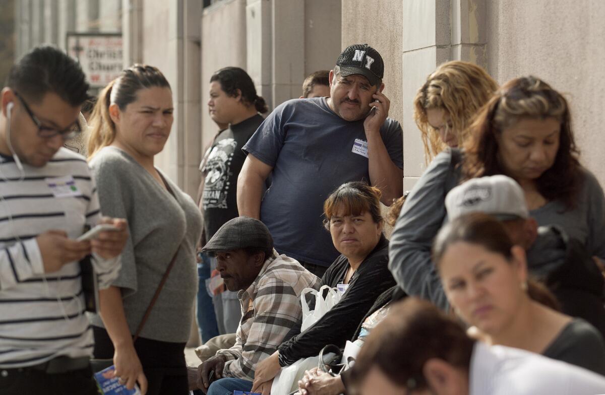 Residents wait in line at Community Coalition to sign up for health insurance last November. SEIU United Healthcare Workers West invited the public to enroll for Medi-Cal and Covered California coverage.
