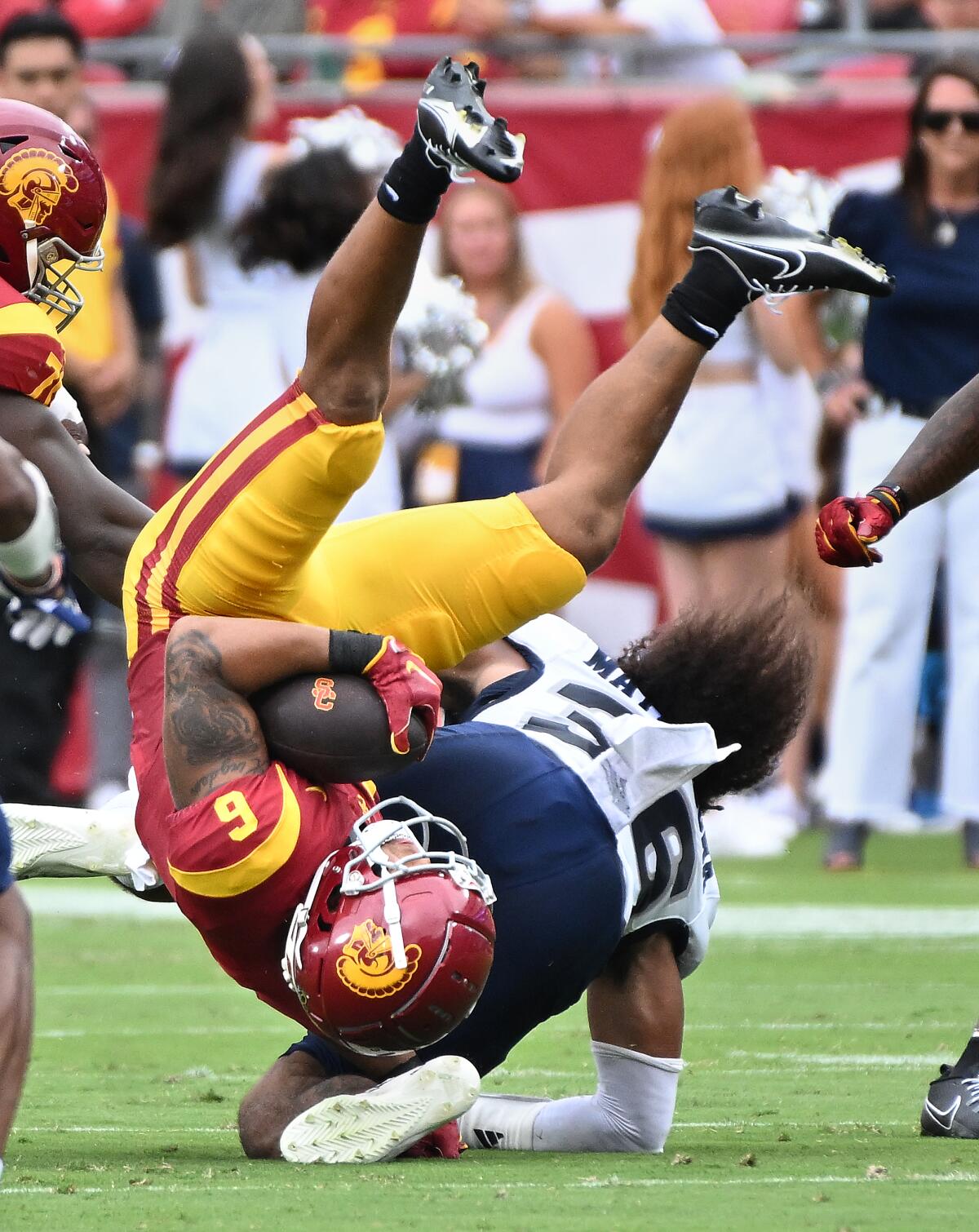 USC running back Austin Jones is upended after a gain against Nevada in the first quarter.