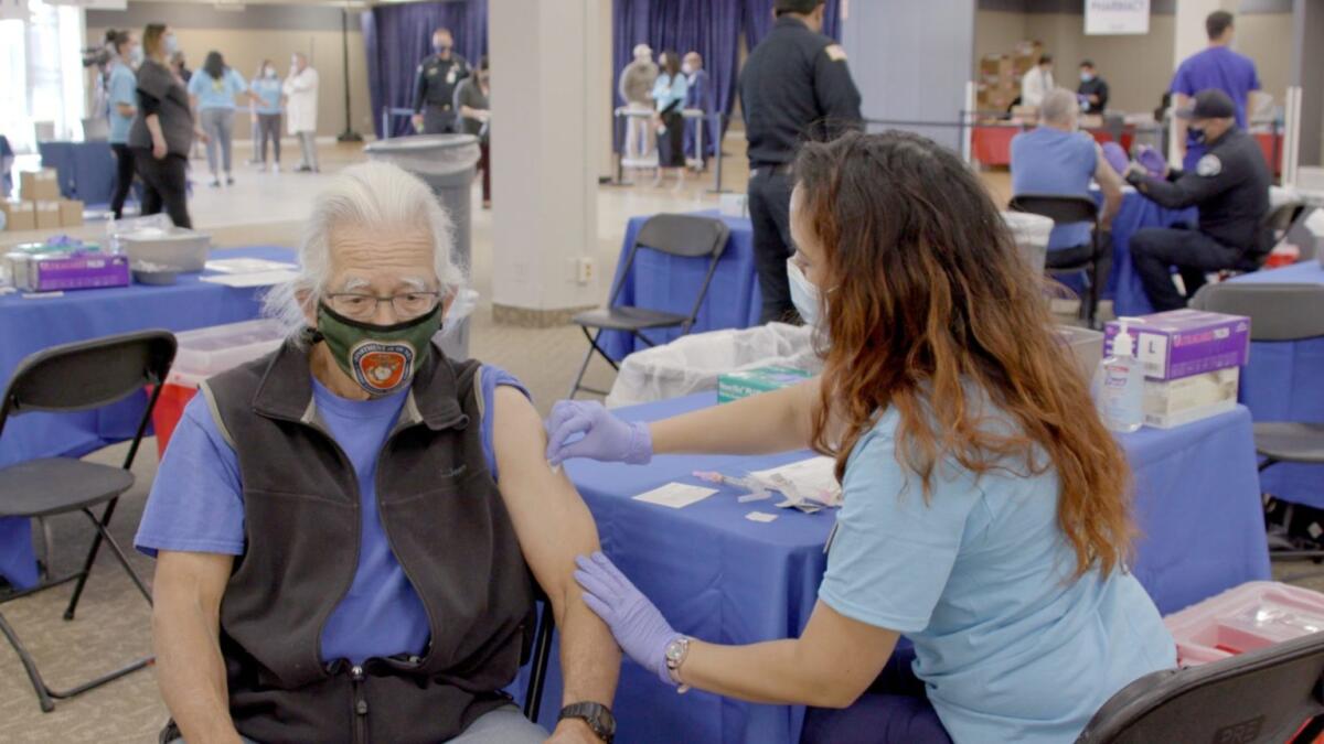 A man receives a vaccination at the county's vaccine super station in Chula Vista.