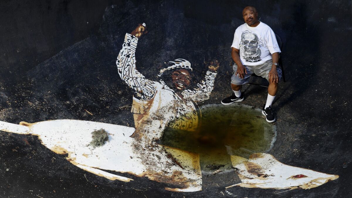Swamp Dogg in his pool, which features a painting inspired by the cover of his 1971 album "Rat On!"