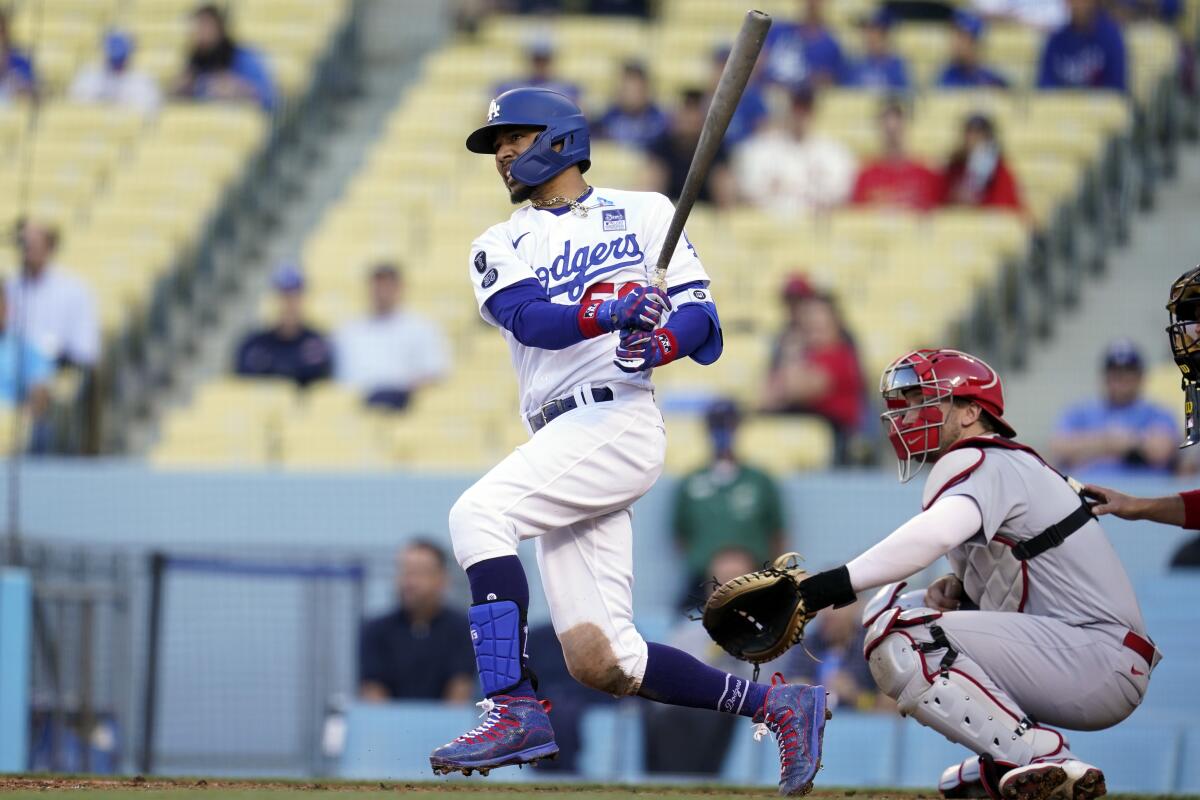 Dodgers' Mookie Betts drives in a run with a single.