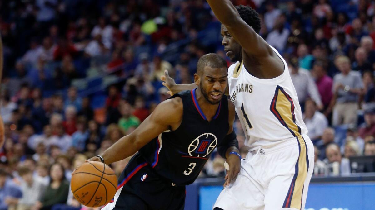 Clippers guard Chris Paul drives to the basket against New Orleans' Jrue Holiday on Dec. 28, 2016. He scored 21 points but missed the next four games after experiencing soreness and fatigue the next day.