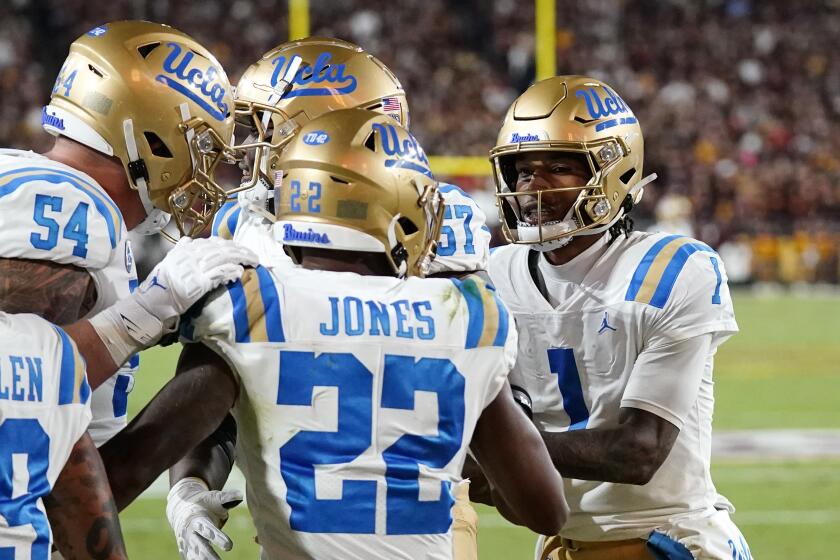 UCLA running back Keegan Jones celebrates with teammates after scoring 